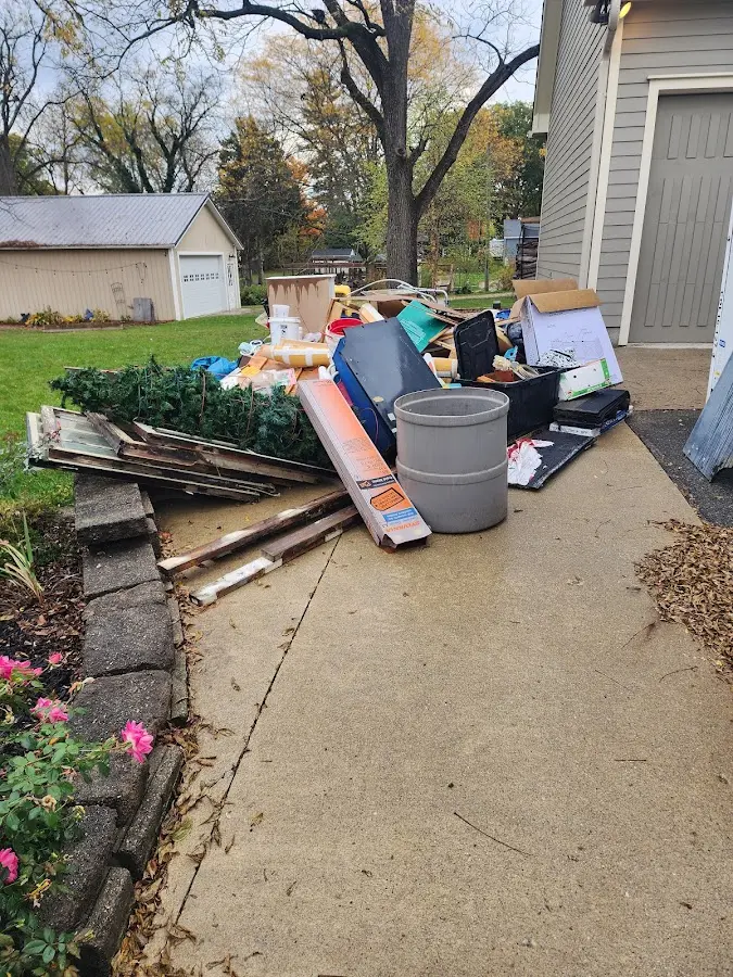 Dumpster being loaded with debris for Residential Dumpster Rental in Pike Road